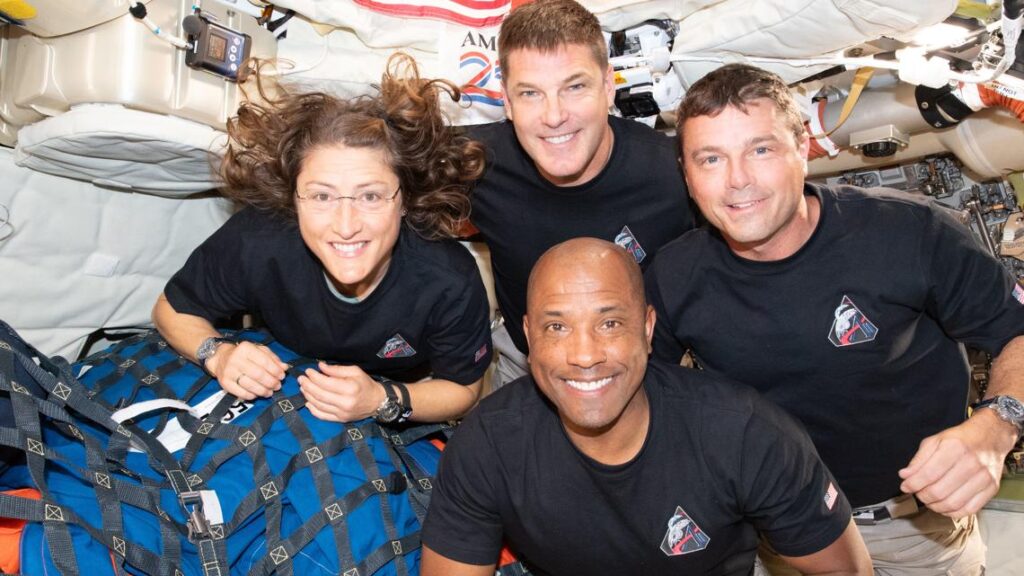 The four Artemis II astronauts posing together in their spacesuits