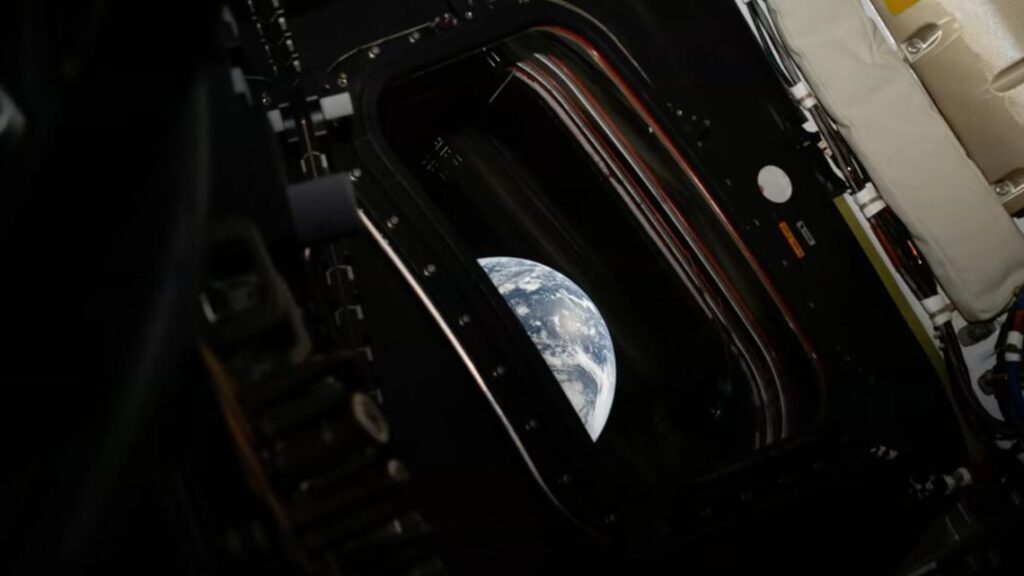 A gracefully curved slice of Earth seen from the Orion capsule in deep space