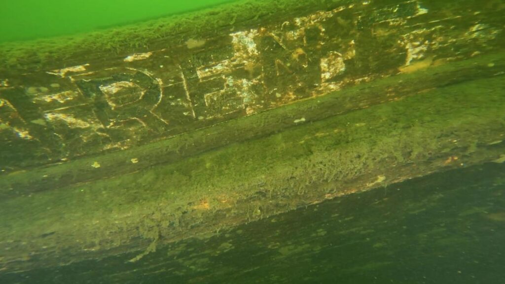 The decaying wooden remains of a historic ship resting on the lakebed