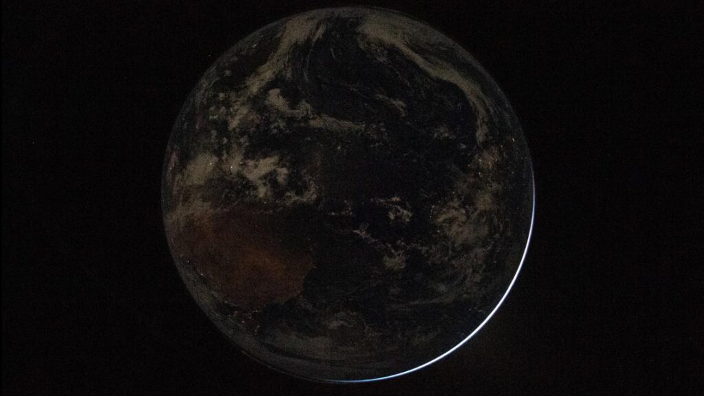 A photograph of the dark side of Earth taken from space during the Artemis II mission.