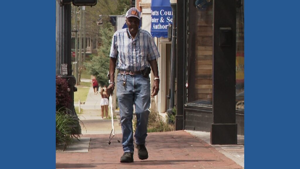 Clemmie Adams, a 90-year-old custodian, standing proudly in Jackson, Georgia