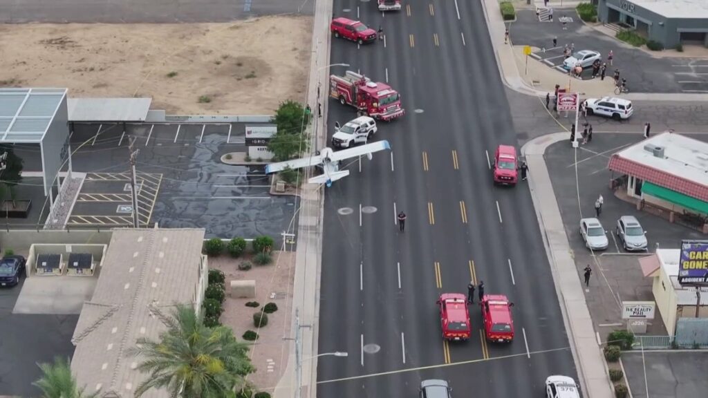 Vintage 1940s seaplane grounded on a busy Phoenix street after an emergency landing