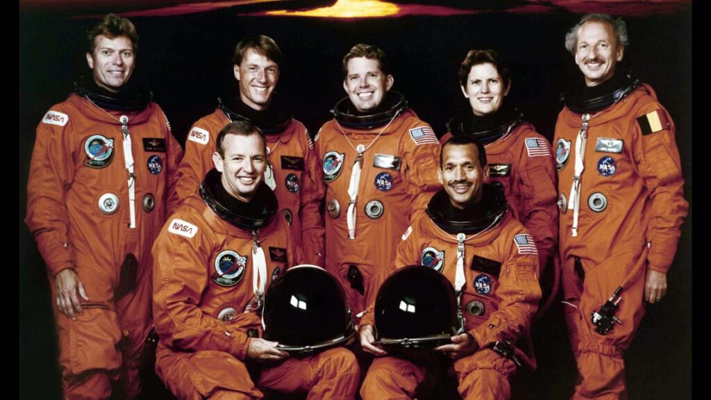 Artemis II astronauts in their high-visibility orange Orion Crew Survival System flight suits